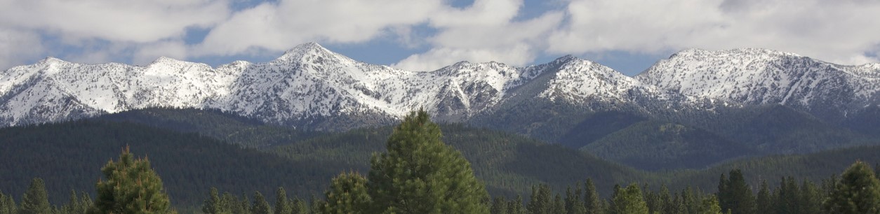Highway leading to snow-capped mountains near Baker City Oregon